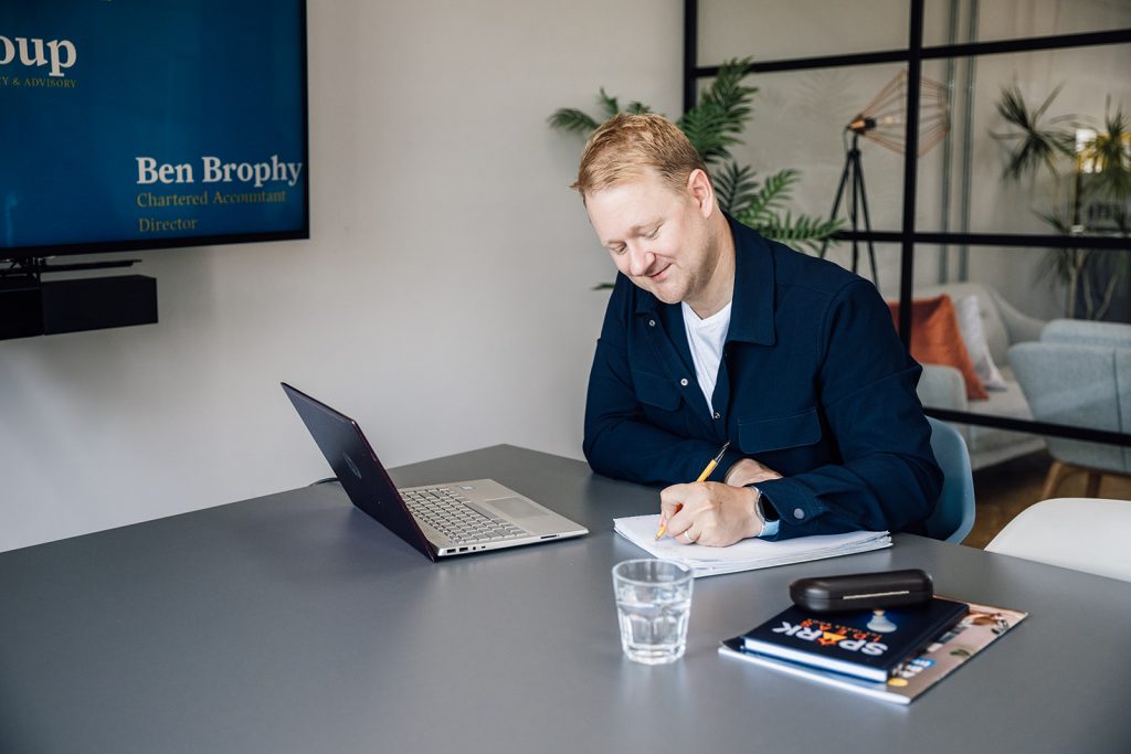 Person writing at a modern desk.